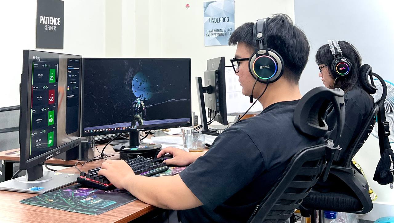 CosuGames team at work — dual monitors and gaming headsets