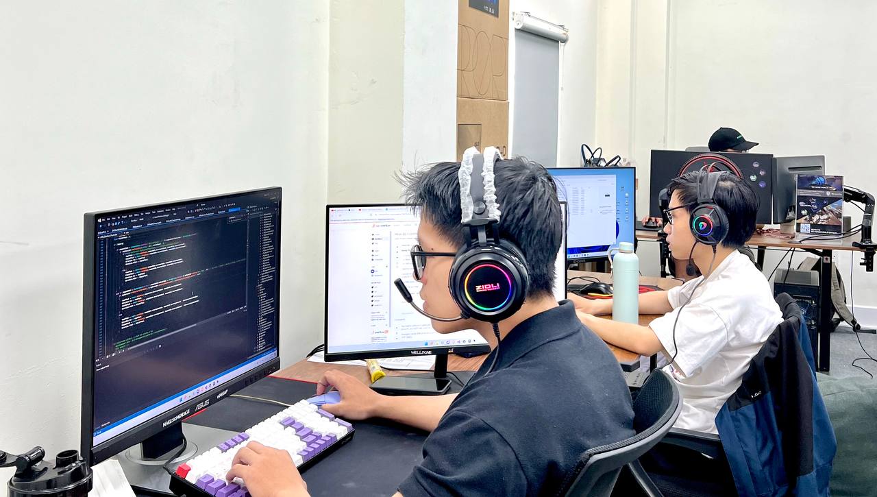 CosuGames developers coding with headsets on